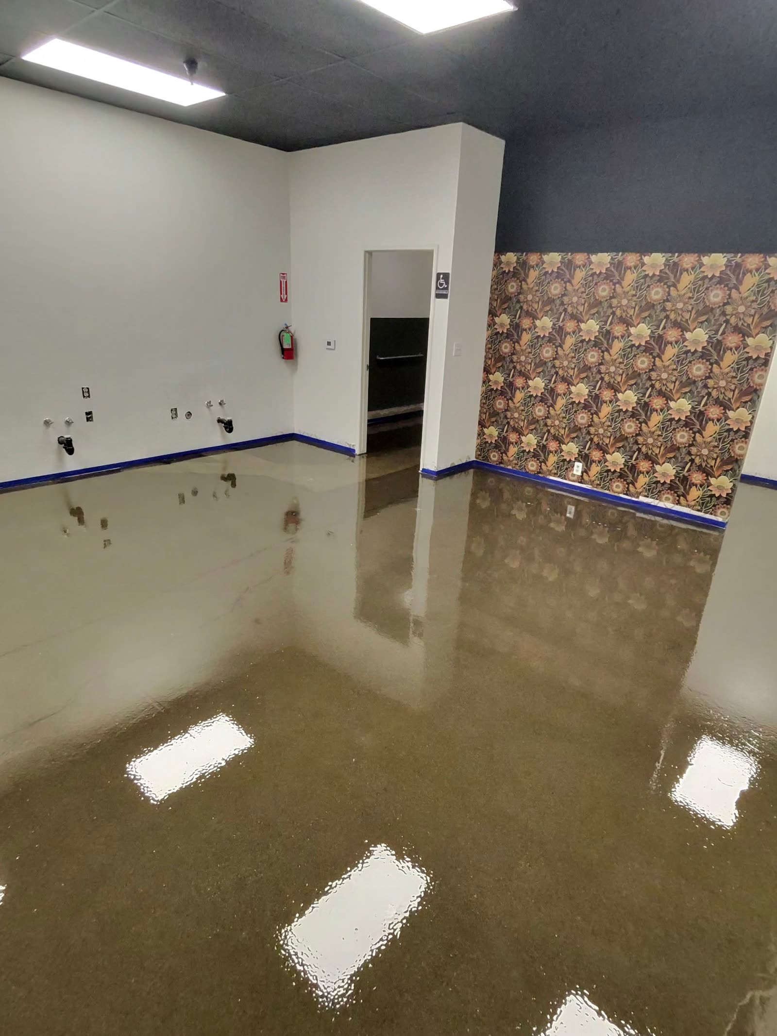 Glossy tan metallic epoxy floor in a finished commercial suite